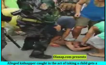 Alleged kidnapper caught in the act of taking a child gets a beatdown from the neighborhood